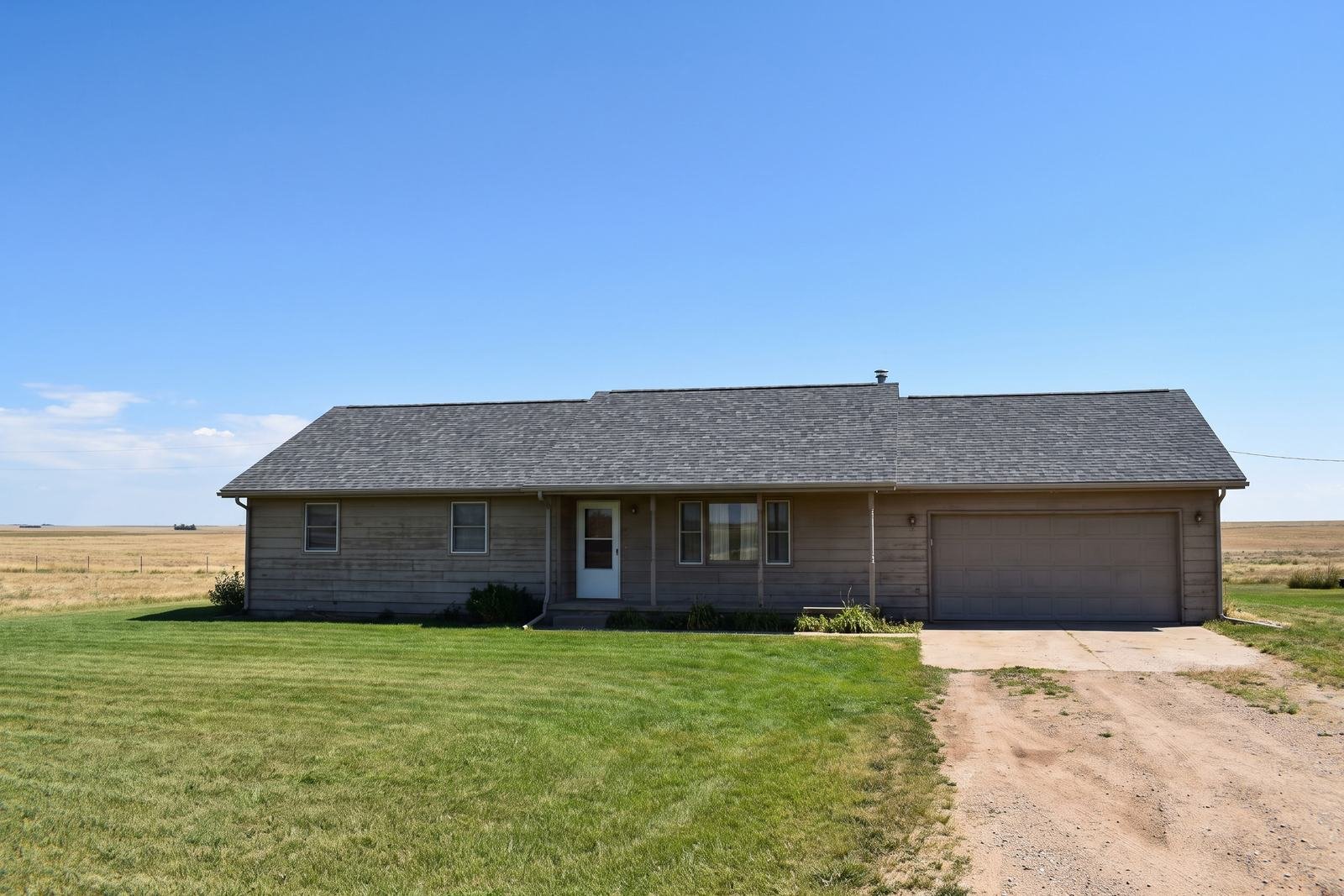 New charcoal architectural shingle roof on a single-story prairie ranch home